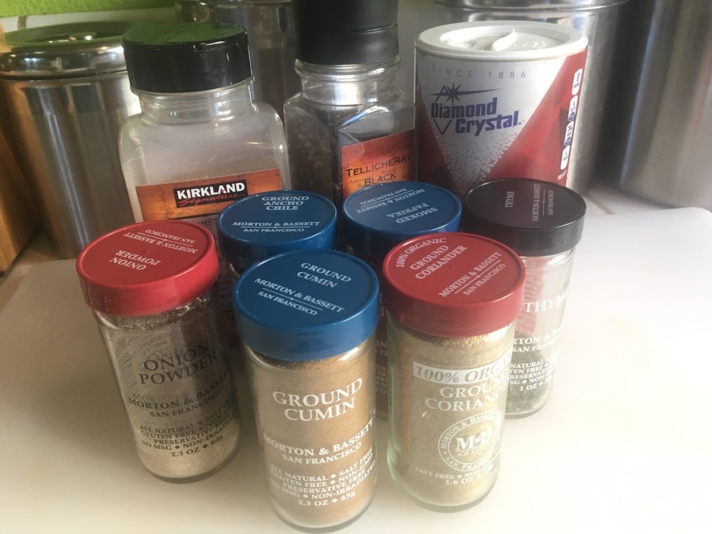 jars of spices on a countertop - best dry rub for ribs